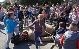 Children using sticks to beat an effigy of Judas on Good Friday, April 19, 2019, in the town of Pruchnik, Poland. (Hubert Lewkowicz / AFP)