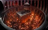 Christian Orthodox worshippers hold up candles lit from the Holy Fire as they gather in the Church of the Holy Sepulchre in Jerusalem's Old City on April 27, 2019 during the Orthodox Easter. (Thomas Coex/AFP)