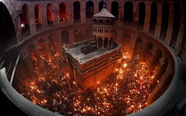Christian Orthodox worshippers hold up candles lit from the Holy Fire as they gather in the Church of the Holy Sepulchre in Jerusalem's Old City on April 27, 2019 during the Orthodox Easter. (Thomas Coex/AFP) Christian Orthodox worshippers hold up candles lit from the Holy Fire as they gather in the Church of the Holy Sepulchre in Jerusalem's Old City on April 27, 2019 during the Orthodox Easter. (Thomas Coex/AFP)