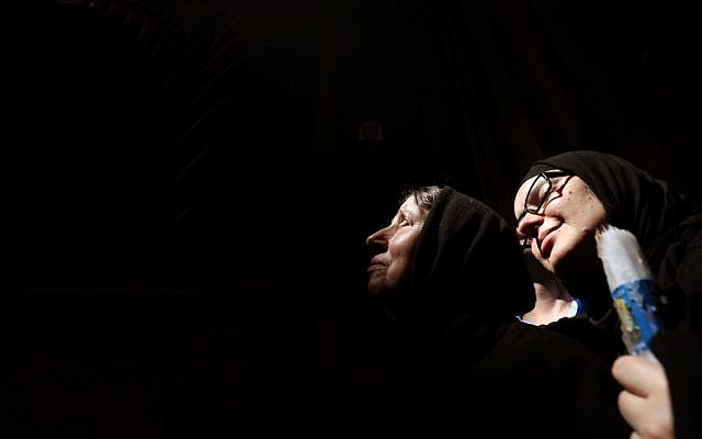 Christian Orthodox worshippers react as a beam of light from the Holy Fire penetrates in the Church of the Holy Sepulchre in Jerusalems Old City on April 27, 2019 during the Orthodox Easter. (GALI TIBBON / AFP) Christian Orthodox worshippers react as a beam of light from the Holy Fire penetrates in the Church of the Holy Sepulchre in Jerusalems Old City on April 27, 2019 during the Orthodox Easter. (GALI TIBBON / AFP)