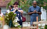 Relatives pay their respects in front of the graves of the victims of recent bomb blasts at St. Sebastian's Church in Negombo, Sri Lanka, on April 28, 2019, a week after a series of jihadist bomb blasts targeted churches and luxury hotels on Easter Sunday. (Ishara S. Kodikara/AFP)
