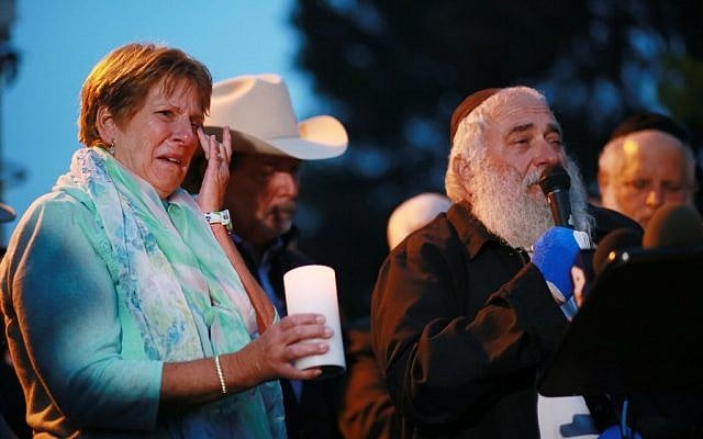 Corrie Vaus (L) wipes a tear, next to her husband, Poway Mayor Steve Vaus (2nd L), while listening to Rabbi Yisroel Goldstein describe the shooting during a candlelight vigil for the victim of the Chabad of Poway Synagogue shooting on April 28, 2019 in Poway, California (SANDY HUFFAKER / AFP) Corrie Vaus (L) wipes a tear, next to her husband, Poway Mayor Steve Vaus (2nd L), while listening to Rabbi Yisroel Goldstein describe the shooting during a candlelight vigil for the victim of the Chabad of Poway Synagogue shooting on April 28, 2019 in Poway, California (SANDY HUFFAKER / AFP)