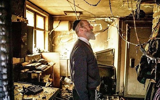 A person inspects the damage from a fire set at the Torat Chaim Yeshiva on the eve of Passover, April 19, 2019 (Courtesy/Torat Chaim Yeshiva) A person inspects the damage from a fire set at the Torat Chaim Yeshiva on the eve of Passover, April 19, 2019 (Courtesy/Torat Chaim Yeshiva)