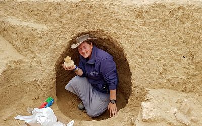 Archaeologist Shira Bloch holds a 2000-year-old vessel discovered in the excavation near Tel Beersheba. (Israel Antiquities Authority)