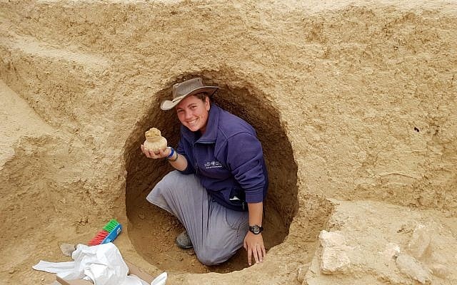 Archaeologist Shira Bloch holds a 2000-year-old vessel discovered in the excavation near Tel Beersheba. (Israel Antiquities Authority)