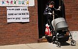 A sign warns of measles in the ultra-Orthodox Jewish community of Williamsburg, Brooklyn, in New York City, April 10, 2019. (Spencer Platt/Getty Images/via JTA)
