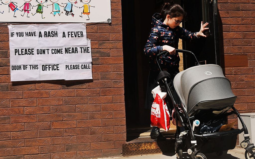 A sign warns of measles in the Orthodox Jewish community of Williamsburg, Brooklyn, in New York City, April 10, 2019. (Spencer Platt/Getty Images via JTA) A sign warns of measles in the Orthodox Jewish community of Williamsburg, Brooklyn, in New York City, April 10, 2019. (Spencer Platt/Getty Images via JTA)