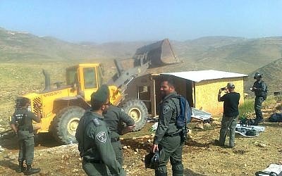 Border Police officers look on as a home in the illegal Maoz Esther outpost is demolished in the central West Bank on April 30, 2019. (Hilltop Youth L'hakeer Mekarov/Facebook)