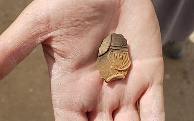 2,000-year-old oil lamp sherd decorated with a nine-branched menorah discovered at an excavation near Tel Beer Sheva. (Anat Rasiuk, Israel Antiquities Authority)