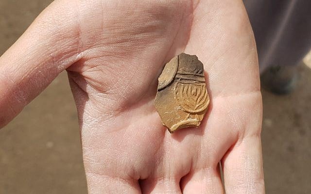 2,000-year-old oil lamp sherd decorated with a nine-branched menorah discovered at an excavation near Tel Beer Sheva. (Anat Rasiuk, Israel Antiquities Authority)