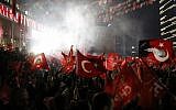 Supporters of the Republican People's Party, CHP, wave Turkish flags, and one with a portrait of Kemal Ataturk, right, as they celebrate after preliminary results of the local elections were announced in Ankara, Turkey, April 1, 2019. (Burhan Ozbilici/AP)