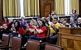 People in attendance applaud after the Pittsburgh City Council voted 6-3 to pass gun-control legislation, Tuesday, April 2, 2019, in Pittsburgh. The bill, introduced in the wake of the synagogue massacre last October, places restrictions on military-style assault weapons like the AR-15 rifle that authorities say was used in the attack that killed 11 and wounded seven. (AP Photo/Keith Srakocic)