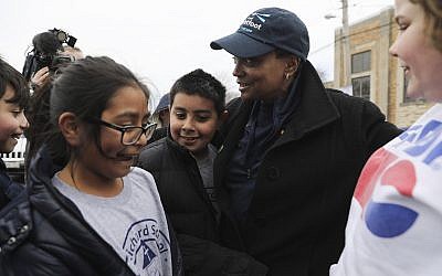 Grammar school students stop to say hello and hug mayoral candidate Lori Lightfoot outside a 14th Ward polling location, Tuesday, April 2, 2019, in Chicago. (Abel Uribe/Chicago Tribune via AP)