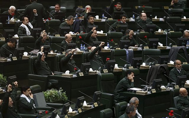 Wearing the uniform of the Islamic Revolutionary Guard Corps, Iranian lawmakers chant 'Death to America' and other slogans during an open session of parliament in Tehran, Iran, on April 9, 2019. (AP Photo/ Hamidreza Rahel/ICANA) Wearing the uniform of the Islamic Revolutionary Guard Corps, Iranian lawmakers chant 'Death to America' and other slogans during an open session of parliament in Tehran, Iran, on April 9, 2019. (AP Photo/ Hamidreza Rahel/ICANA)