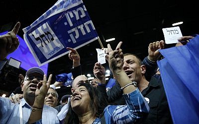Likud party supporters cheer at the party's campaign headquarters after polls close in Knesset elections, in Tel Aviv, in the early hours of April 10, 2019. (AP Photo/Ariel Schalit)