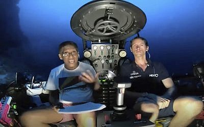 An image taken from video issued by Nekton shows Seychelles President Danny Faure, left, speaking from inside a submersible from the vessel Ocean Zephyr, under the water off the coast of Desroches, in the outer islands of Seychelles, April 14, 2019. (Nekton via AP)