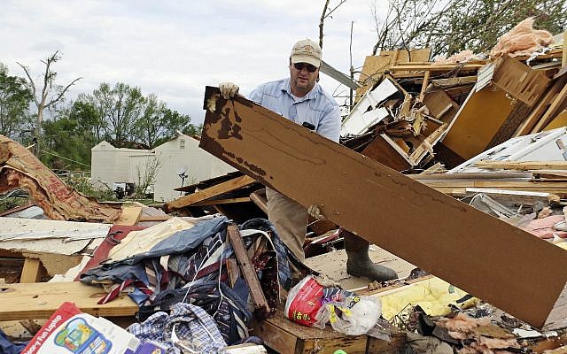 Roman Brown moves part of a wall out of his way as he looks for a friend's medicine in their destroyed home along Seely Drive outside of Hamilton, Mississippi, after a storm moved through the area on April 14, 2019. (AP Photo/Jim Lytle) Roman Brown moves part of a wall out of his way as he looks for a friend's medicine in their destroyed home along Seely Drive outside of Hamilton, Mississippi, after a storm moved through the area on April 14, 2019. (AP Photo/Jim Lytle)