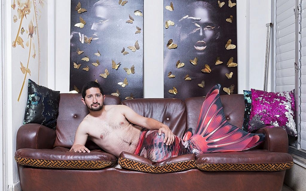 In this Thursday, Feb. 28, 2019 photo, Gal Amnony, a member of the Israeli Mermaid Community, poses for a portrait as he wears a tail at his home in Ramat Gan, Israel. (AP Photo/Oded Balilty)