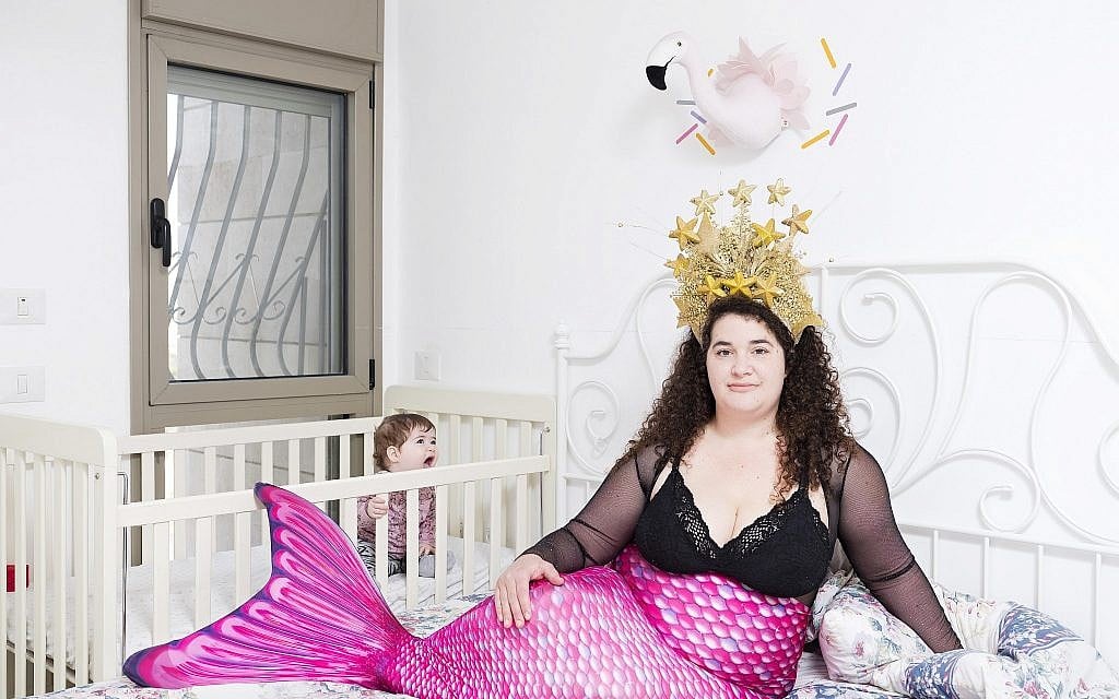 In this Friday, Feb. 22, 2019 photo, Hadas Kellner, a member of the Israeli Mermaid Community, poses for a portrait as she wears a mermaid tail at her home in Yahud, Israel. (AP Photo/Oded Balilty)
