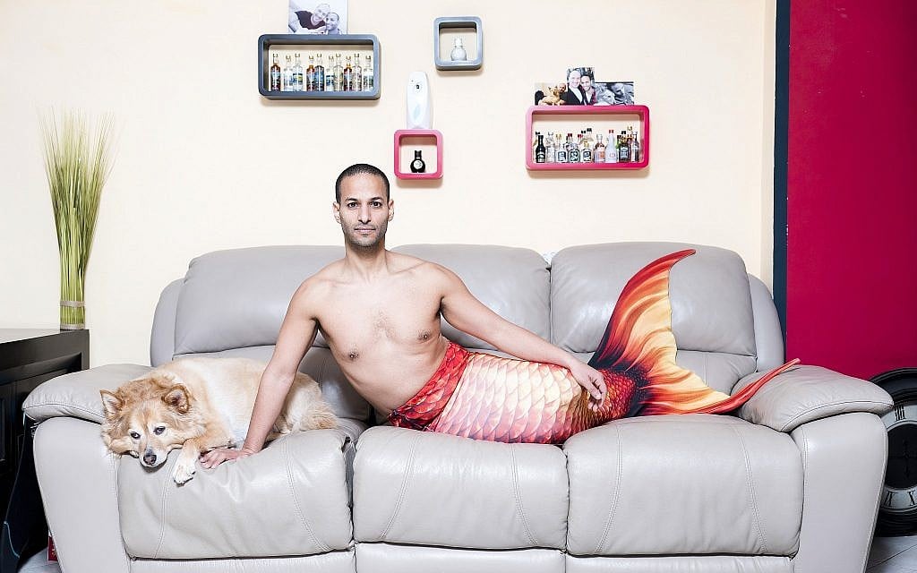 In this Friday, Feb . 22, 2019 photo, Udi Frige, a member of the Israeli Mermaid Community, poses for a portrait as he wears a mermaid tail at his home in Yahud, Israel. (AP Photo/Oded Balilty)
