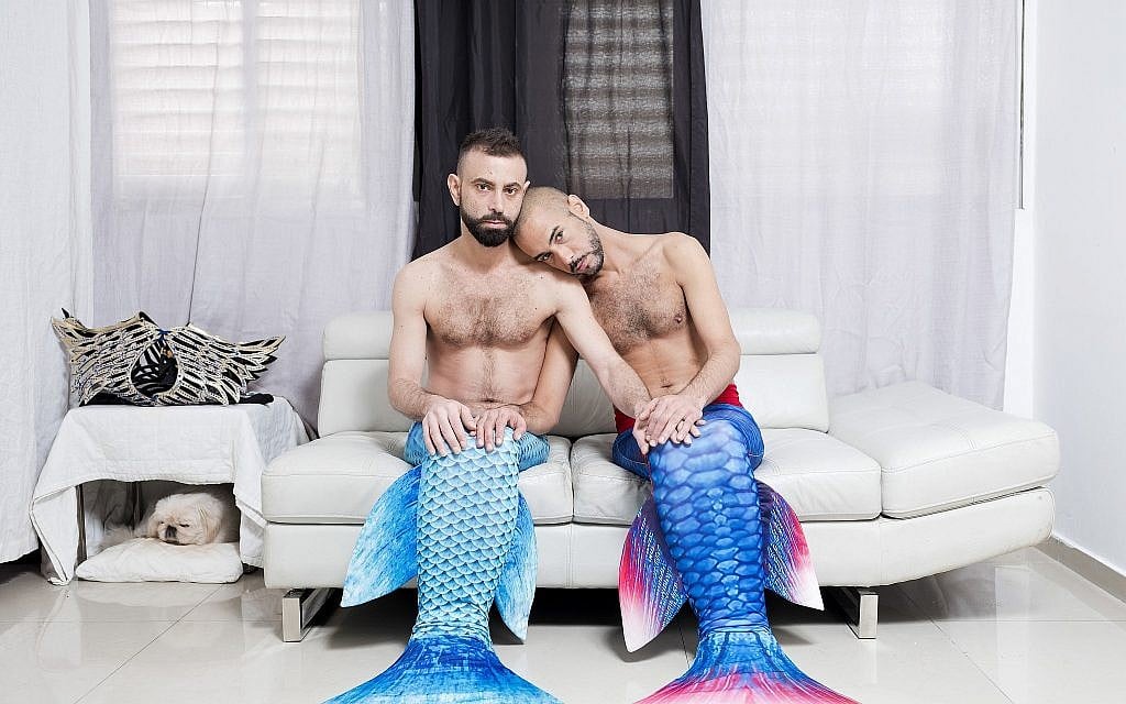 In this Thursday, Feb. 21, 2019 photo, Adi Kazav, left, and Lied Adi Hagbi, members of the Israeli Mermaid Community, pose for a portrait as they wear mermaid tails at their home in Netanya, Israel. (AP Photo/Oded Balilty)