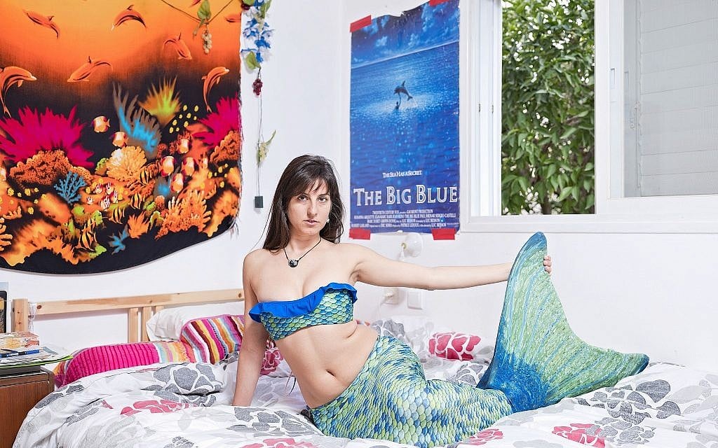 In this Monday, March. 4, 2019 photo, Ligal Shternhell, a member of the Israeli Mermaid Community, poses for a portrait as she wears a mermaid tail at her home in Kibbutz Ein Carmel, Israel. (AP Photo/Oded Balilty)