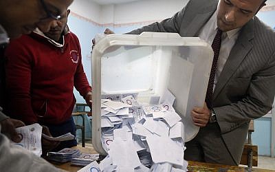 Election workers count ballots at the end of a referendum on constitutional amendments at a polling station in Cairo, Egypt, on April 22, 2019. (AP Photo/Amr Nabil)
