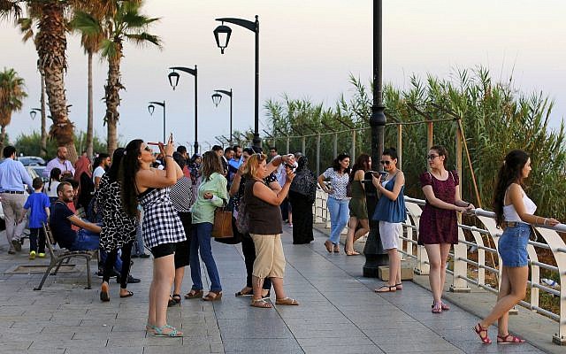 Tourists takes pictures, as the sun sets over the Mediterranean Sea in Beirut, Lebanon, on June 30, 2017. (AP Photo/Hassan Ammar/File) Tourists takes pictures, as the sun sets over the Mediterranean Sea in Beirut, Lebanon, on June 30, 2017. (AP Photo/Hassan Ammar/File)