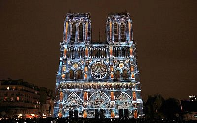 The Notre Dame cathedral is illuminated during a light show called "Dame de Cœur" to celebrate the centenary of the First World War, in Paris, Wednesday, Nov. 8, 2017. (AP/Christophe Ena)