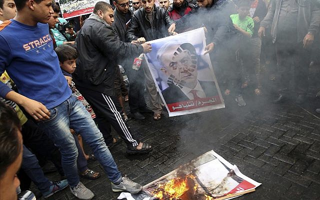 Illustrative: Hamas supporters burn a picture of the Prime Minister Benjamin Netanyahu during protest against US President Donald Trump's decision to recognize Jerusalem as Israel's capital, in Jebaliya Refugee Camp, Gaza Strip, December 8, 2017. (AP Photo/Adel Hana) Illustrative: Hamas supporters burn a picture of the Prime Minister Benjamin Netanyahu during protest against US President Donald Trump's decision to recognize Jerusalem as Israel's capital, in Jebaliya Refugee Camp, Gaza Strip, December 8, 2017. (AP Photo/Adel Hana)