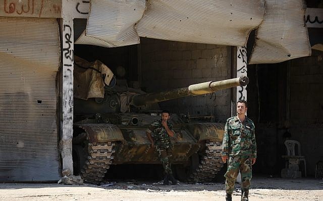 File: Syrian soldiers stand guard at their military post on the entrance of the central Syrian town of Rastan, Homs province, Syria, Tuesday, July 17, 2018. (AP Photo/Hassan Ammar) File: Syrian soldiers stand guard at their military post on the entrance of the central Syrian town of Rastan, Homs province, Syria, Tuesday, July 17, 2018. (AP Photo/Hassan Ammar)