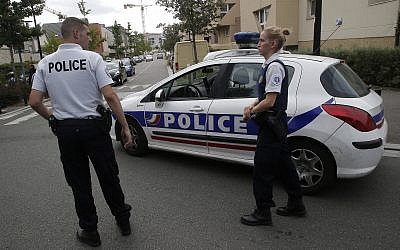 FILE - Police officers in Trappes, west of Paris, Aug. 23, 2018 (AP Photo/Michel Euler)