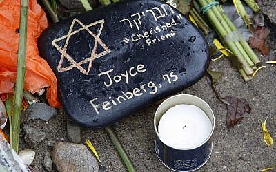 A stone memorializing Joyce Fienberg (spelling on stone differs) at a makeshift memorial outside the Tree of Life Synagogue to the 11 people killed October 27, 2018 while worshiping in the Squirrel Hill neighborhood of Pittsburgh November 1, 2018. (AP Photo/Gene J. Puskar)