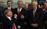 US President Donald Trump, left, turns to give a pen to Israeli Prime Minister Benjamin Netanyahu, center, at the White House in Washington, March 25, 2019 after signing the official proclamation formally recognizing Israel's sovereignty over the Golan Heights. From left, White House adviser Jared Kushner, US special envoy Jason Greenblatt, US Ambassador to Israel David Friedman, Israeli Ambassador to the US Ron Dermer, and Secretary of State Mike Pompeo. (AP/Susan Walsh)
