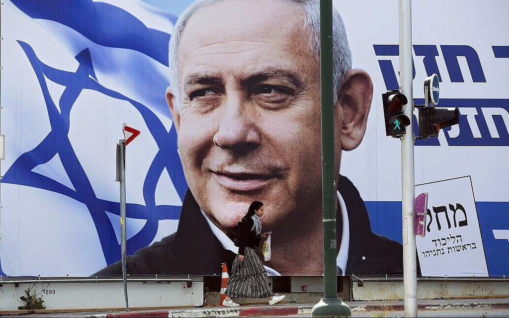 A woman walks by an election campaign billboard in Tel Aviv, March 28, 2019, showing Prime Minister Benjamin Netanyahu. (AP/Oded Balilty) A woman walks by an election campaign billboard in Tel Aviv, March 28, 2019, showing Prime Minister Benjamin Netanyahu. (AP/Oded Balilty)