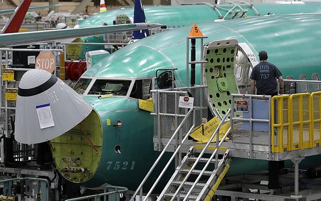 In this March 27, 2019, file photo, a worker enters a Boeing 737 MAX 8 airplane during a brief media tour of Boeing's 737 assembly facility in Renton, Washington (AP Photo/Ted S. Warren, File) In this March 27, 2019, file photo, a worker enters a Boeing 737 MAX 8 airplane during a brief media tour of Boeing's 737 assembly facility in Renton, Washington (AP Photo/Ted S. Warren, File)