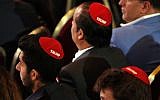 Men attending the Republican Jewish Coalition's annual leadership meeting wear red yarmulkes with the word 'Trump' on them, April 6, 2019, as they wait for President Donald Trump to arrive to speak in Las Vegas. (AP Photo/Jacquelyn Martin)