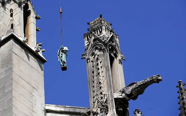 The statue representing St. Paul descends to earth for the first time in over a century as part of a restoration of Notre Dame Cathedral in Paris, April 11, 2019. (AP /Francois Mori) The statue representing St. Paul descends to earth for the first time in over a century as part of a restoration of Notre Dame Cathedral in Paris, April 11, 2019. (AP /Francois Mori)