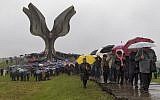 Hundreds gather at the memorial center to pay their respects for tens of thousands of people killed in death camps run by Croatia's pro-Nazi puppet state in WWII, in Jasenovac, Croatia, Friday, April 12, 2019. (AP Photo/Nikola Solic)