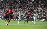 Manchester United's Paul Pogba scores the opening goal from the penalty spot during the English Premier League soccer match between Manchester United and West Ham United at Old Trafford stadium in Manchester, England, Saturday, April 13, 2019. (AP/Rui Vieira)
