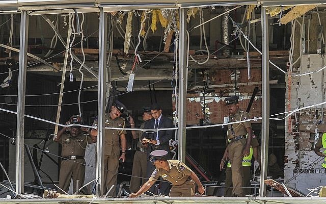 A Sri Lankan Police officer inspects a blast spot at the Shangri-la hotel in Colombo, Sri Lanka, April 21, 2019. (AP/Chamila Karunarathne)