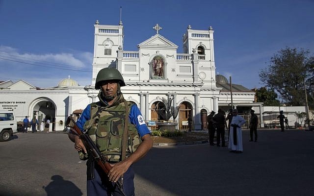 Sri Lankan air force officers and clergy stand outside St. Anthony's Shrine, a day after a blast in Colombo, Sri Lanka, April 22, 2019. (AP Photo/Gemunu Amarasinghe) Sri Lankan air force officers and clergy stand outside St. Anthony's Shrine, a day after a blast in Colombo, Sri Lanka, April 22, 2019. (AP Photo/Gemunu Amarasinghe)