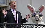 US President Donald Trump, joined by the Easter Bunny, speaks from the Truman Balcony of the White House in Washington on April 22, 2019, during the annual White House Easter Egg Roll. (AP Photo/Alex Brandon)