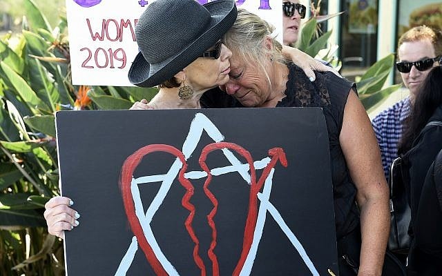 Leslie Gollub, left, and Gretchen Gordon hug at a vigil held to support the victims of Saturday's shooting at Chabad of Poway synagogue, on April 28, 2019, in Poway, Calif. (AP/Denis Poroy) Leslie Gollub, left, and Gretchen Gordon hug at a vigil held to support the victims of Saturday's shooting at Chabad of Poway synagogue, on April 28, 2019, in Poway, Calif. (AP/Denis Poroy)
