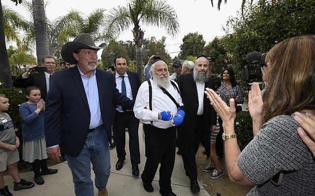 Poway mayor Steve Vaus (L) accompanies Rabbi Yisroel Goldstein as he arrives at a news conference at the Chabad of Poway synagogue, Sunday, April 28, 2019, in Poway, Calif. (AP Photo/Denis Poroy) Poway mayor Steve Vaus (L) accompanies Rabbi Yisroel Goldstein as he arrives at a news conference at the Chabad of Poway synagogue, Sunday, April 28, 2019, in Poway, Calif. (AP Photo/Denis Poroy)