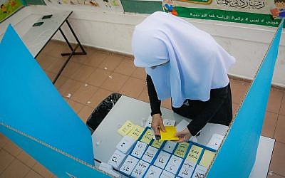 Illustrative: An Arab Israeli woman casts her ballot at a voting station in municipal elections on October 30, 2018, in Kafr Kasm. (Roy Alima/Flash90)