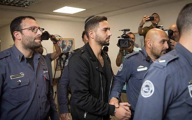 Netanel Sandrusi is taken to the traffic court in Jerusalem after being arrested on suspicion that he ran over an 11-year-old child, critically wounding him, and then fleeing the scene, April 29, 2019. (Hadas Parush/Flash90) Netanel Sandrusi is taken to the traffic court in Jerusalem after being arrested on suspicion that he ran over an 11-year-old child, critically wounding him, and then fleeing the scene, April 29, 2019. (Hadas Parush/Flash90)