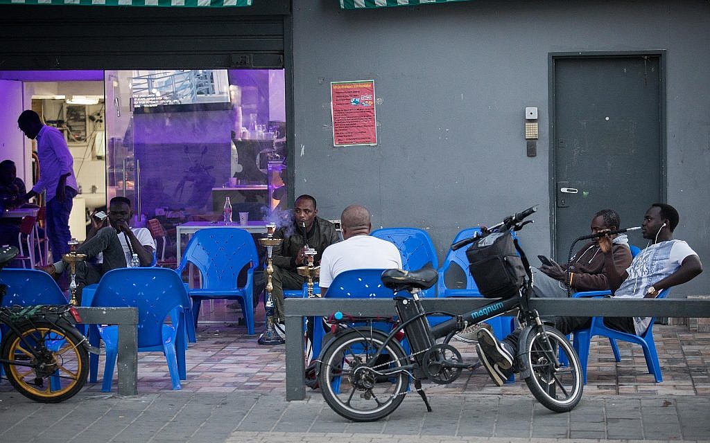 Customers smoke nargila at a Sudanese-style tavern in south Tel Aviv. (Hadas Porush/Flash90)