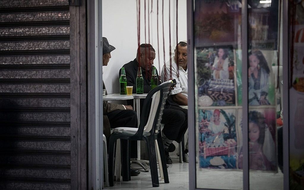 Customers drink beer in an Eritrean hamara in south Tel Aviv. (Hadas Porush/Flash90)