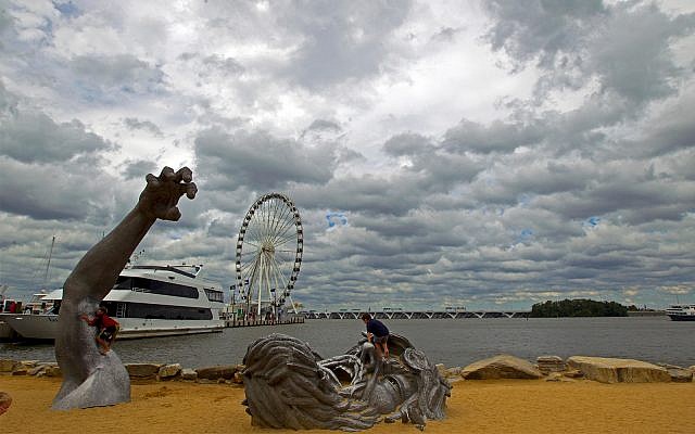 Illustrative: Children play on a sculpture at National Harbor, Maryland, September 3, 2016. The site was targeted in an IS-inspired terror attack by 28-year-old Rondell Henry, federal prosecutors said on April 8, 2019. (AP Photo/Jose Luis Magana, File) Illustrative: Children play on a sculpture at National Harbor, Maryland, September 3, 2016. The site was targeted in an IS-inspired terror attack by 28-year-old Rondell Henry, federal prosecutors said on April 8, 2019. (AP Photo/Jose Luis Magana, File)